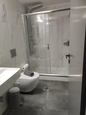 a bathroom with a shower and a toilet and a sink at Porto Chania in Chania Town