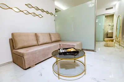a living room with a couch and a glass table at Konmari Boutique Suites in Chania Town