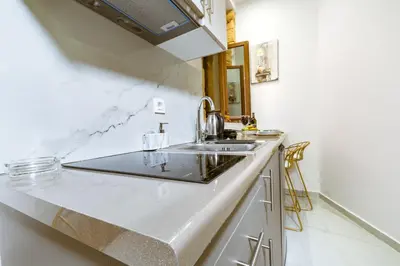 a kitchen with a sink and a counter top at Konmari Boutique Suites in Chania Town