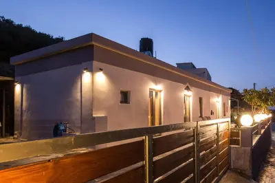 a small house with lights on the side of it at M & E Kissamos sea view house in Kissamos