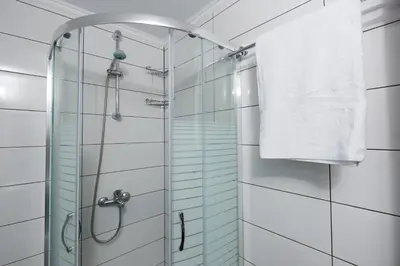 a bathroom with a glass shower with a towel at M & E Kissamos sea view house in Kissamos