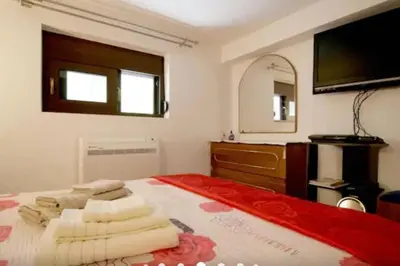 a bedroom with a large bed with a large mirror at Apartment with Premium Facilities in Chania Town