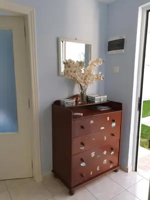a dresser with a vase on top of it at Nikoleta Apartment in Chania Town