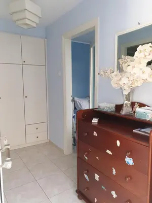 a room with a dresser with a vase on it at Nikoleta Apartment in Chania Town