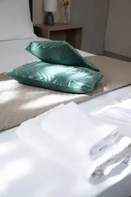 a green pillow sitting on top of a bed at Calme luxury residence in Chania Town