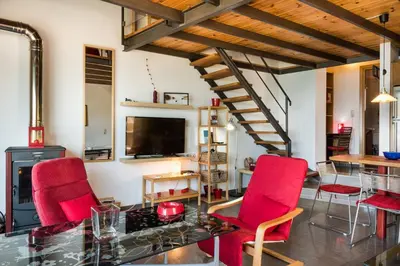 a living room with a glass table and red chairs at House with Private Place To Swim, Solitary, View in Ravdhoúkha