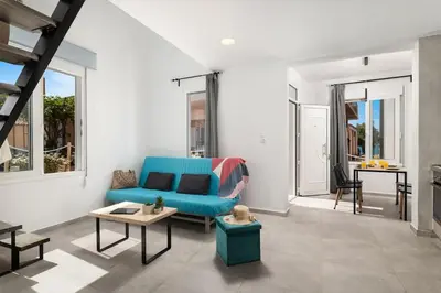 a living room with a blue couch and a table at 