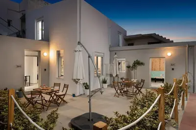 a patio with tables and chairs and a building at 