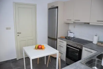a kitchen with a table with a bowl of fruit on it at Chania 1548 Old Town Apartments in Chania Town