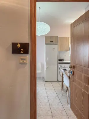 a kitchen with a white refrigerator and a table at Alisahni Home 2 in Daratso