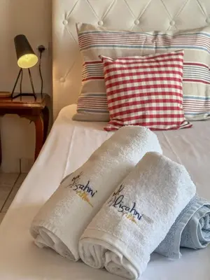 two towels sitting on top of a bed at Alisahni Home 2 in Daratso