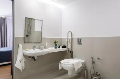 a bathroom with a sink and a toilet and a mirror at Balance Hotel in Chania Town