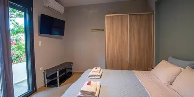 a bedroom with a bed with two towels on it at On the sand 2 in Palaiochóra
