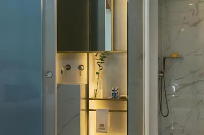 a bathroom with a shower and a glass door at Mirabile Luxury Suites in Chania Town