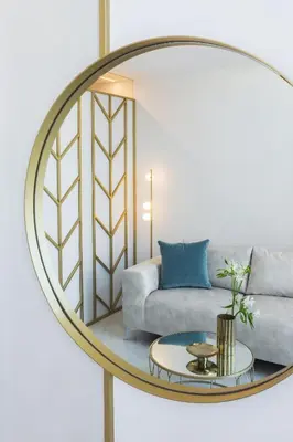 a mirror in a living room with a couch and a table at Mirabile Luxury Suites in Chania Town