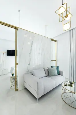 a white living room with a white couch and a table at Mirabile Luxury Suites in Chania Town