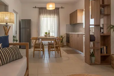 a kitchen and living room with a table and chairs at eden of grameno in Palaiochóra