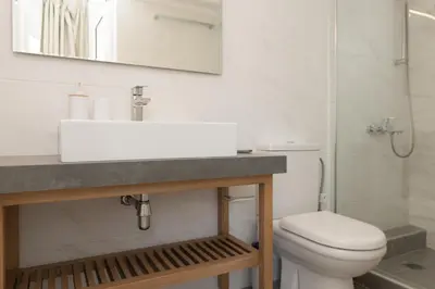 a bathroom with a sink and a toilet at eden of grameno in Palaiochóra