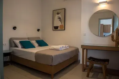a bedroom with a bed and a mirror at eden of grameno in Palaiochóra