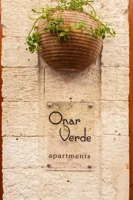 a plant in a basket hanging on a wall at Charming Flatlet in the Old Town in Chania Town