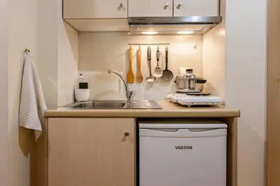 a small kitchen with a sink and a counter at Charming Flatlet in the Old Town in Chania Town