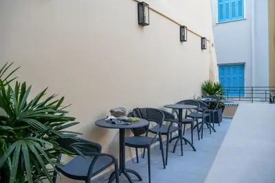 a row of tables and chairs on a patio at Camere Maritima in Chania Town