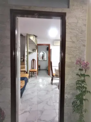 a hallway with a mirror and a room with a bed at Matzi House in Chania Town
