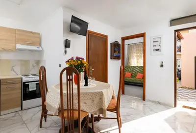a kitchen and dining room with a table and chairs at Matzi House in Chania Town