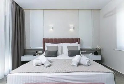 a bedroom with a large bed with white pillows at Limosa Luxury Residences in Kissamos