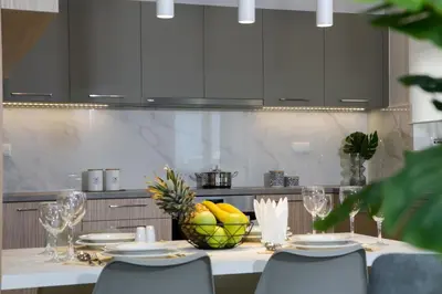 a kitchen with a table with a bowl of fruit on it at Limosa Luxury Residences in Kissamos