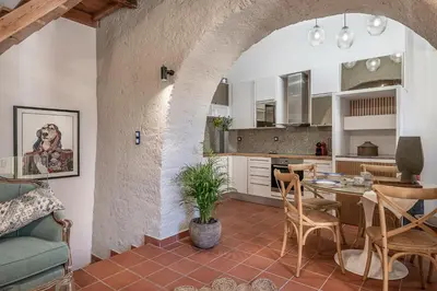 a kitchen and living room with a table and chairs at Agazade Bey in Chania Town