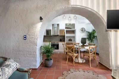 a kitchen and dining room with a table and chairs at Agazade Bey in Chania Town