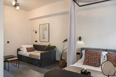 a living room with a bed and a couch at Anaem Eclectic Rooms in Chania Town