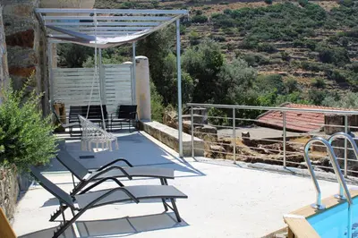 a patio with a table and chairs next to a pool at INO II Domus POOL by Amigdalokefali Elafonissi in AmigdhalokeFálion