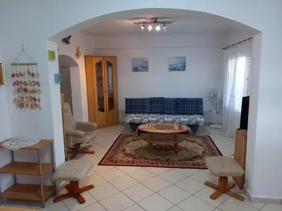 a living room with a blue couch and a table at Alexandros cosy house for family vacation in Chania Town