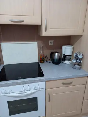 a kitchen with a white stove and a counter top at Alexandros cosy house for family vacation in Chania Town