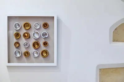 a group of gold buttons on a shelf on a wall at Semeli Apartment in Kissamos