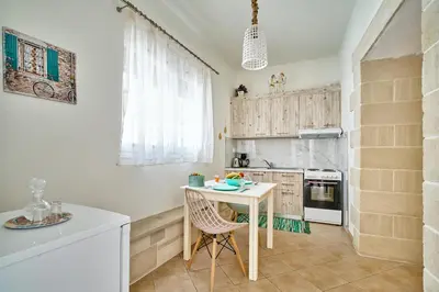 a kitchen with a small table and a counter at Semeli Apartment in Kissamos
