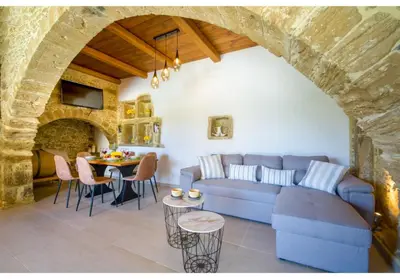 a living room with a blue couch and a table at Villa Arietta in Kharkhalianá