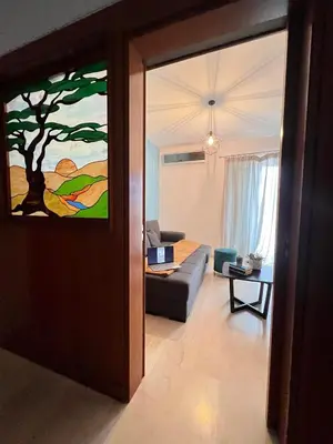a living room with a couch and a painting on the wall at Vitro art House-in the heart of Chania in Chania Town
