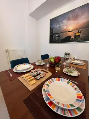 a dining room table with plates on top of it at Vitro art House-in the heart of Chania in Chania Town