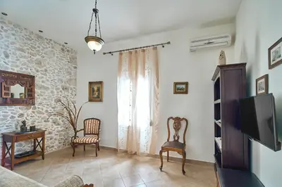 a living room with a couch and a tv at Ekavi Apartment in Kissamos