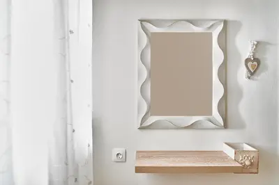 a mirror on a wall with a wooden shelf at Ekavi Apartment in Kissamos