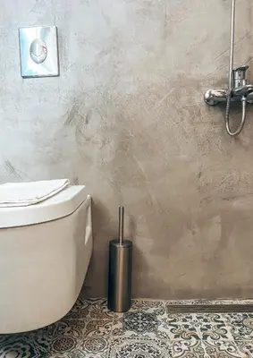 a bathroom with a toilet and a wall at Elafonisi Rooms For Rent in Elafonisi