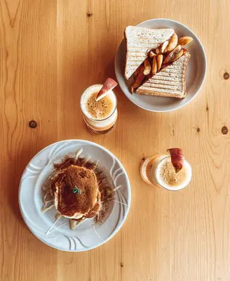 a table with two plates of food and toast at Elafonisi Rooms For Rent in Elafonisi