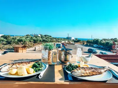 a table with two plates of food on a table at Elafonisi Rooms For Rent in Elafonisi