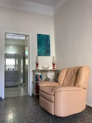 a living room with a brown couch in a room at Reina House in Chania Town
