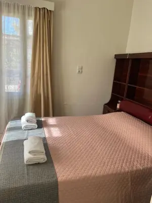 a bedroom with a bed with two towels on it at Reina House in Chania Town