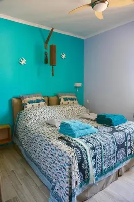 a bedroom with a large bed with blue walls at Casa Anthos free parking in Chania Town