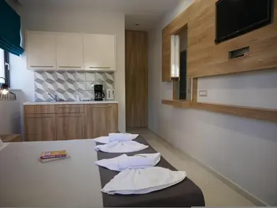 a group of pillows sitting on a table in a kitchen at Erotokritos Studios near the beach in Agia Marina Nea Kydonias